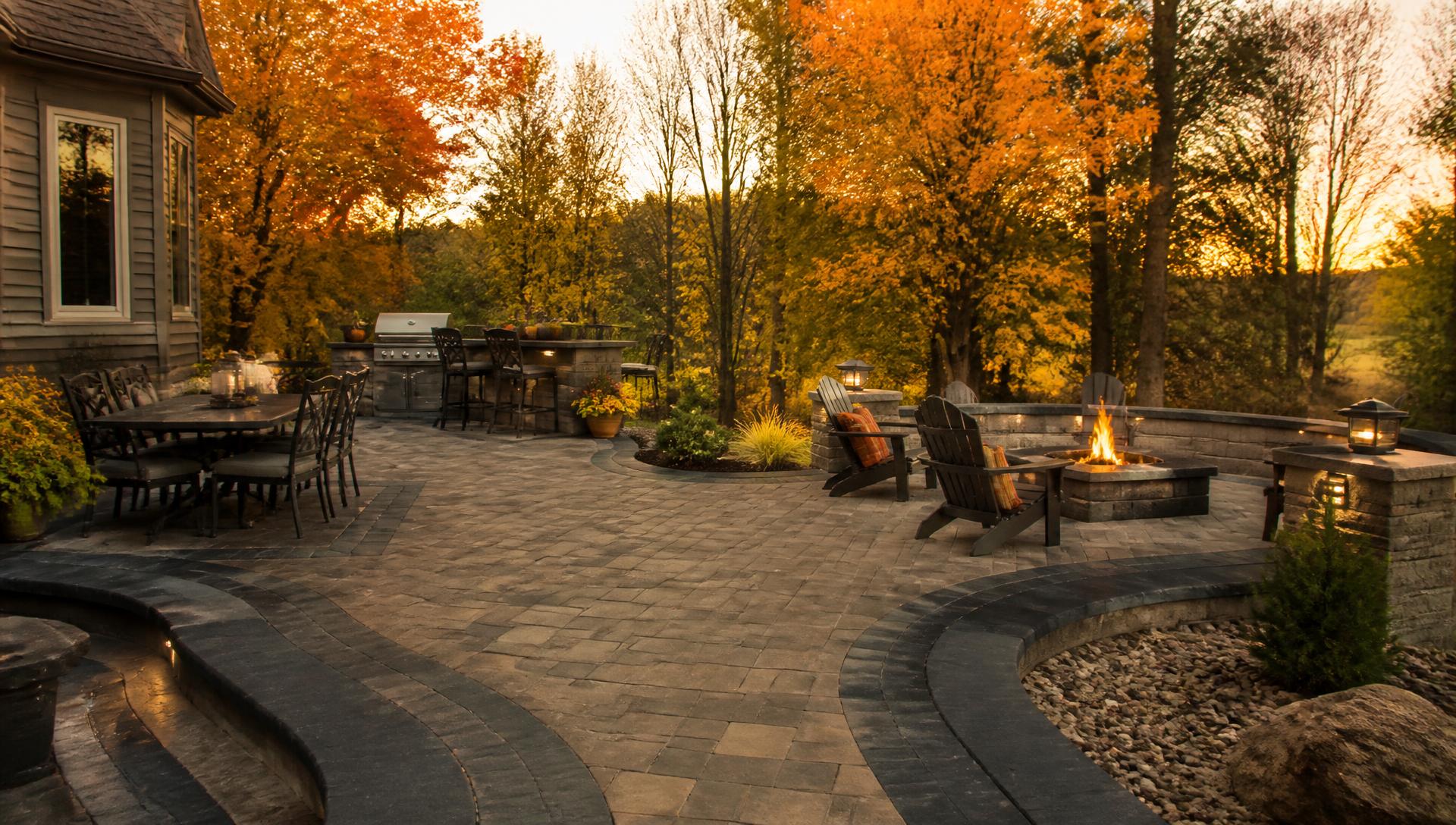 Custom paver patio with fire pit and seating wall built in Central Wisconsin